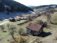 Mountain pasture with two buildings
